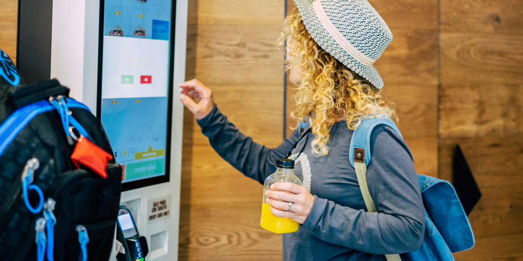 woman ordering food using a digital signage kiosk display